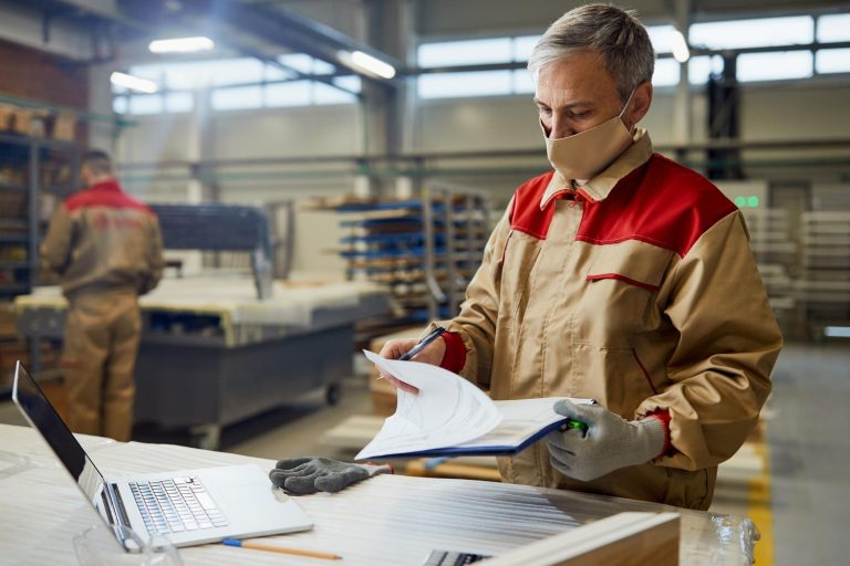 Operator pracujący na zrobotyzowanej linii produkcyjnej zgodnie z instrukcją