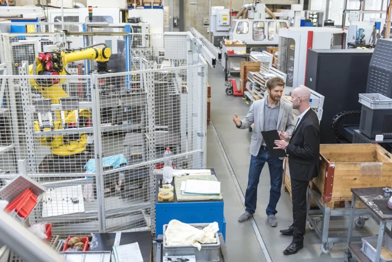 two-businessmen-discussing-modern-factory